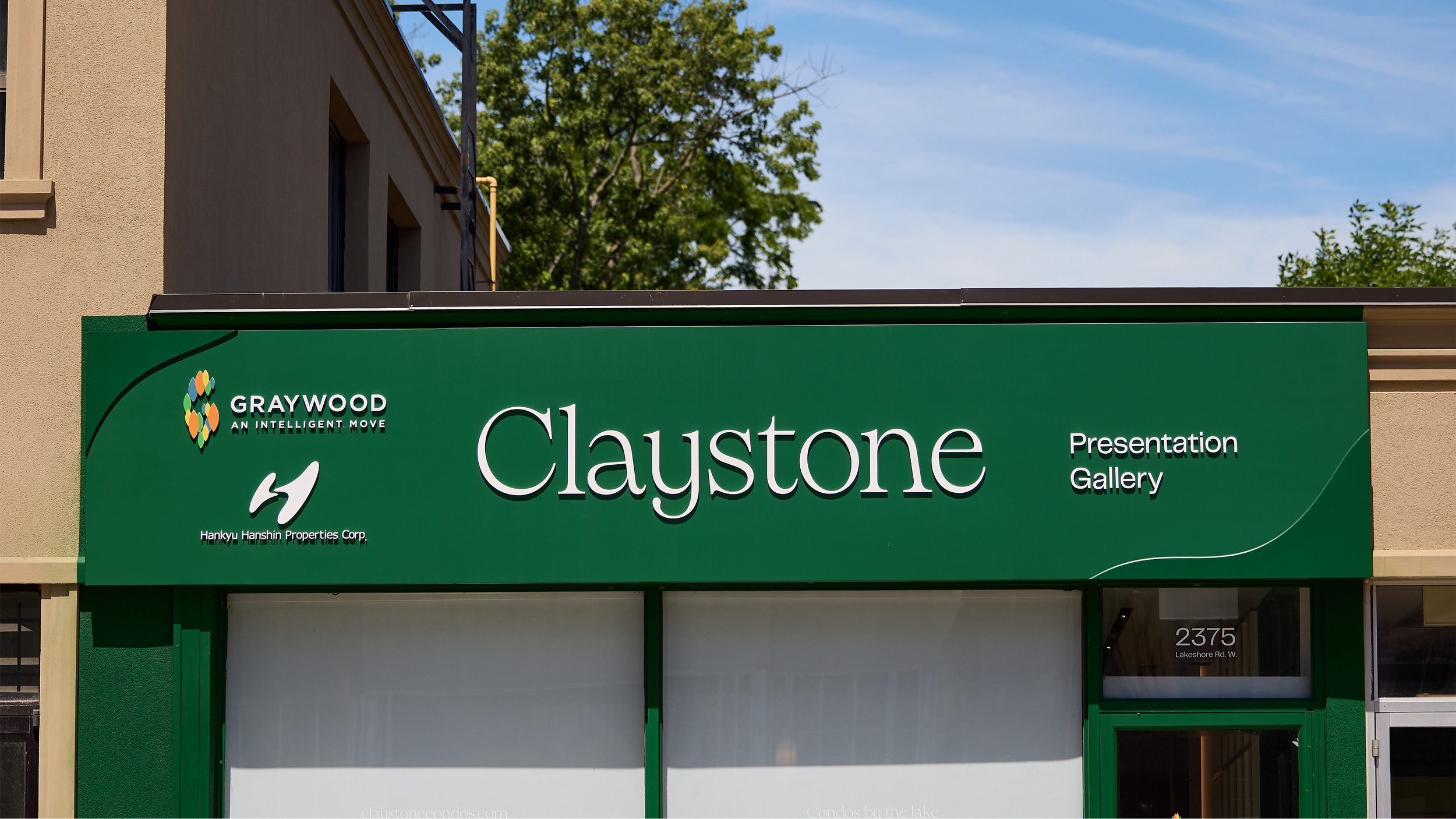 Exterior view of the Claystone sales office featuring branded facade signage.