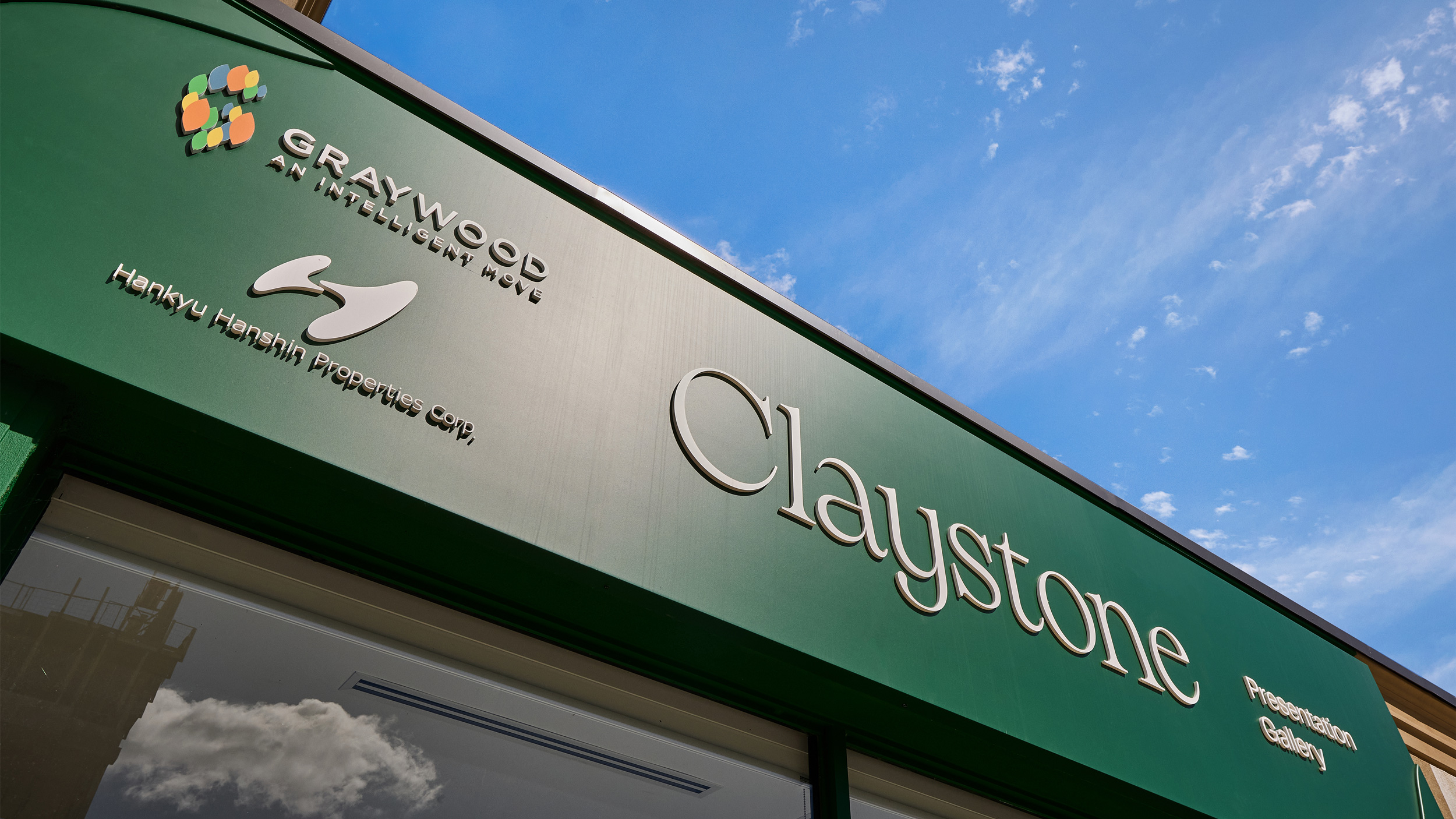 Exterior view of the Claystone sales office featuring branded facade signage.